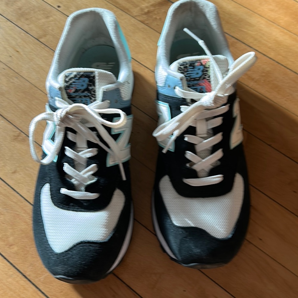 New Balance 574 navy, blk, white with springy leopard floral design. Size 11